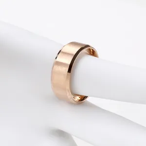 Macro detail of wide rose gold steel ring with brushed texture and polished edges