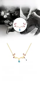 Detail of elk antler necklace featuring pink zircon and blue teardrop stone pendant