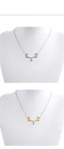 Detail of elk antler necklace featuring pink crystals and blue teardrop pendant