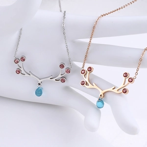 Detail view of elk horn necklaces in silver and rose gold with zircon and blue gemstones