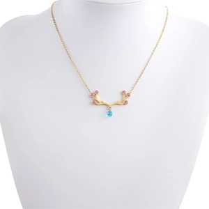 Close-up of golden elk necklace with pink stones and a blue teardrop pendant
