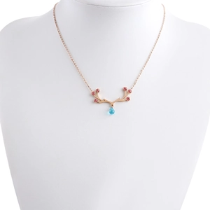 Detail of reindeer pendant necklace in rose gold with pink and blue crystal teardrop