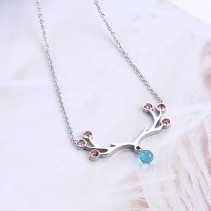 Reindeer antler necklace with blue teardrop crystal and pink stones on white feathers