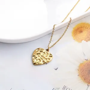 Macro detail of golden textured heart pendant necklace on vintage background