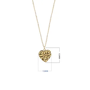 Detail of 15mm gold heart pendant necklace featuring unique hammered texture surface