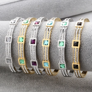Detailed close-up of wide stainless steel bangles with double-row crystals and square stones