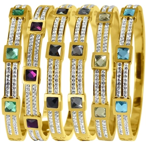 Detailed close-up of six gold-plated steel bracelets with vibrant square gemstones