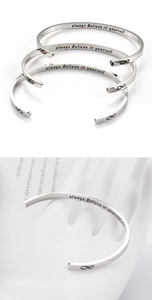 Detail showing infinity symbol and always believe in yourself engraving on silver cuff