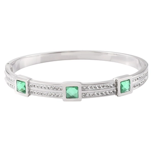 Macro view of silver steel bracelet featuring square emerald gems and pavé zircon stones