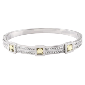 Macro detail of silver titanium bangle featuring square yellow stones and micro pavé zircon