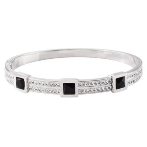 Macro detail of silver titanium steel bangle with square black stones and pavé set crystals