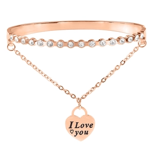 Macro shot of rose gold stainless steel bracelet with sparkling rhinestones and heart tag