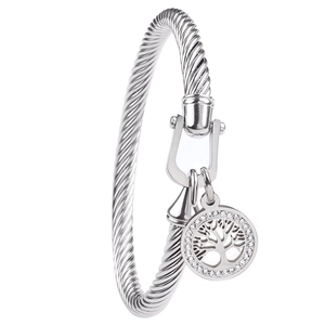 Detail of silver cable bangle with horseshoe clasp and sparkling Tree of Life charm