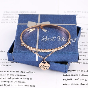 Detail of rose gold heart charm bracelet with crystals and I Love You engraving