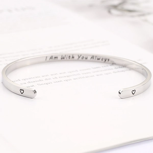 Detail of engraved I Am With You Always quote on polished silver stainless steel cuff