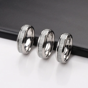 Macro shot of silver stainless steel rings with meteorite texture and polished edges