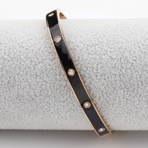 Bracelet jonc en émail noir avec bords dorés et cristaux étincelants pour femmes