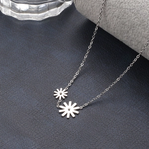 Elegant stainless steel necklace featuring a double daisy pendant on a delicate chain