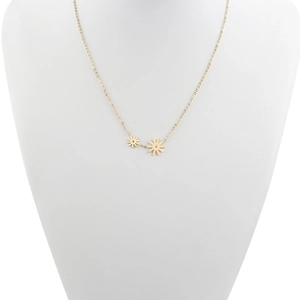 Detail of delicate gold daisy pendant necklaces on white neck mannequin display stand