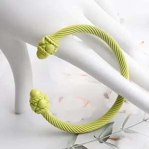 Detailed close-up of grass green twisted cable cuff bracelet with decorative end caps