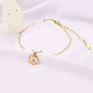 Detail of gold evil eye anklet with lobster clasp and adjustable stainless steel chain