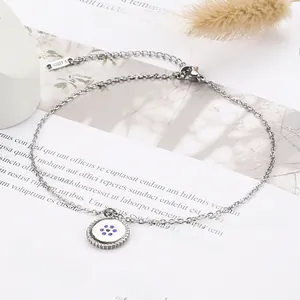 Detail showing silver stainless steel Evil Eye bracelet with blue crystal inlay