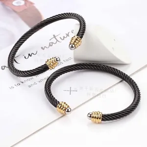 Adjustable black twisted wire cable bracelet with gold and silver steel end caps