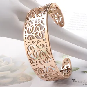 Detailed view of rose gold cutout flower pattern on a stainless steel open bangle bracelet