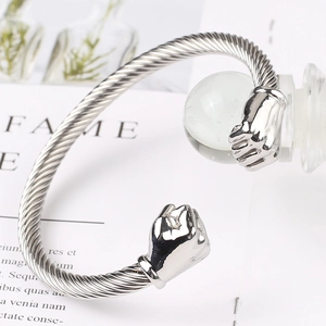 Macro shot of silver twisted cable bracelet with fist ends and polished finish