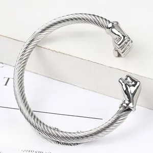 Close-up of silver stainless steel cable twisted bracelet featuring realistic fist ends