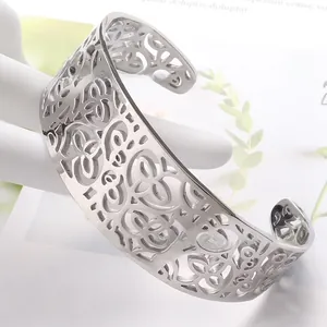 Close-up of hollow flower pattern on silver stainless steel wide cuff bracelet