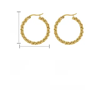 Macro detail of gold-plated braided stainless steel hoop earrings with 32mm height and 4g weight
