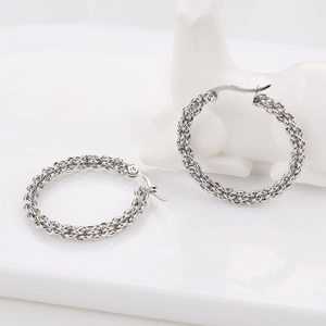 Macro shot of silver woven texture hoop earrings with polished chain-link rope detail