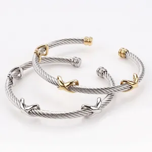 Two-tone stainless steel cable bracelets with gold infinity cross design and sphere end caps