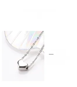 Detail view of heart-shaped titanium steel necklace with a polished silver finish