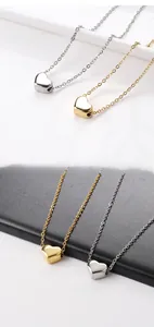 Detailed comparison of gold and silver heart pendants in high-polished stainless steel