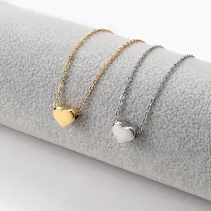 Detailed macro shot of gold and silver heart pendants on elegant stainless steel chains