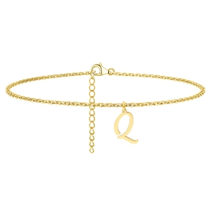 Detail of gold ankle bracelet with hanging letter Q charm and lobster clasp closure