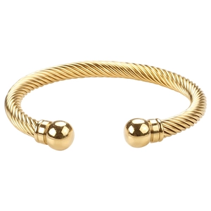 Polished gold cable twist cuff bracelet with metal sphere ends on white background