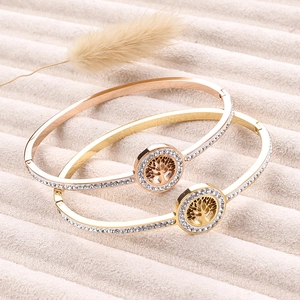 Gold and rose gold stainless steel Tree of Life bangles with paved rhinestones