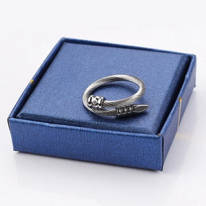 Close-up of a silver twisted cable ring with a sparkling stud head on a blue gift box