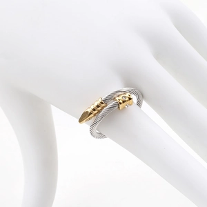 Detailed macro view of two-tone twisted cable ring with crystal-set gold hardware tips