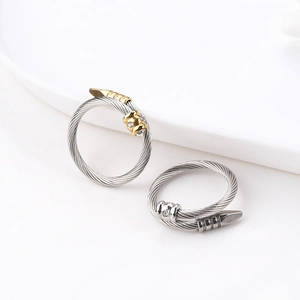 Detail of twisted cable open rings in gold and silver finish with zircon accents