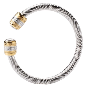 Detail of twisted cable design on two-tone stainless steel cuff bracelet with golden ends