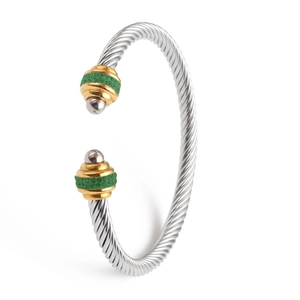Twisted cable cuff bracelet in silver and gold tone with green resin accents
