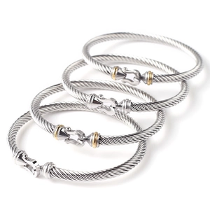 Set of four stainless steel cable twisted bracelets with horseshoe buckle in silver and gold