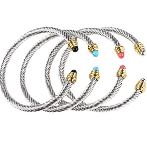 Detail of four wire-twist bangles with colorful beaded ends and gold-threaded screw caps