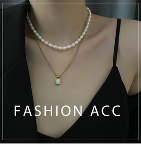 Close-up of double-layer necklace with freshwater pearls and shell pendant on model