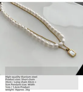 Detail of layered titanium steel necklace with natural freshwater pearls and shell pendant