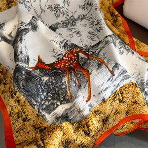 Détail d'un foulard en satin de soie avec imprimé cerf et bords ourlés orange
